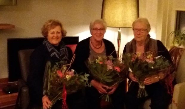 Drie gehuldigde vrijwilligers. Foto: PR