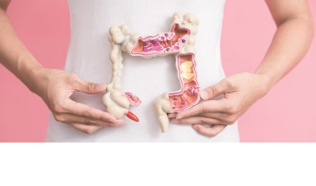 woman with colorectal cancer concept on the pink backgorund