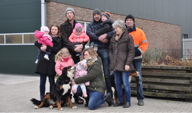 Drie generaties familie Van Winden voor hun schuur vol zonnepanelen. Ze gaan leveren aan Altena Nieuwe Energie.