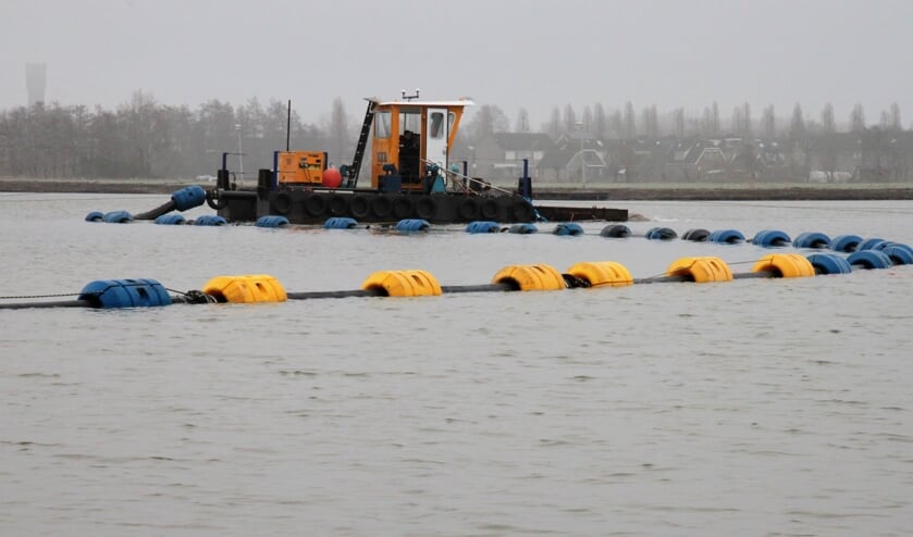 • Het zand voor de bodem gaat via pijpen naar een bootje. Van daaruit wordt het geleidelijk in de surfplas gesproeid.