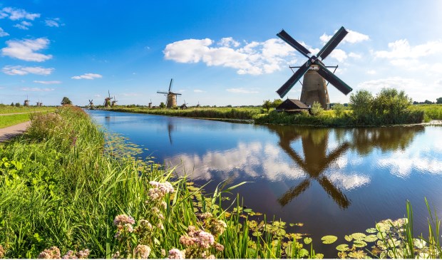 Windmills and water canal in Kinderdijk in a beautiful summer day, Holland