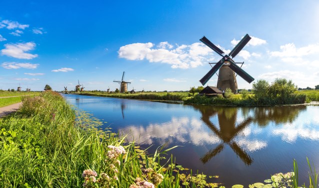 Windmills and water canal in Kinderdijk in a beautiful summer day, Holland