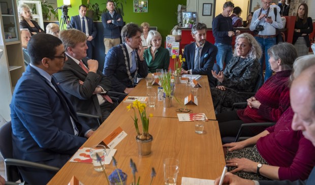 Koning Willem-Alexander (tweede van links) met rechtsachter aan de tafel Natalie Gallicola, projectleider van Zoete Kruimels. Foto: pr