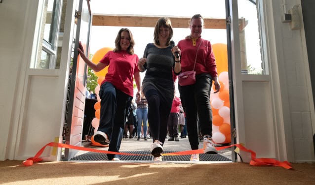 Twee medewerkers van Werkom met in het midden Natasja Groothuismink openen de vestiging.