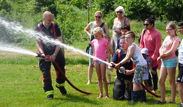 Kinderen mogen spuiten met een echte brandweerslang.