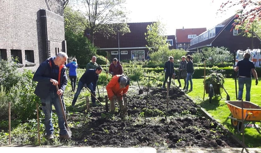 Rotaryleden aan het werk voor de moestuin.