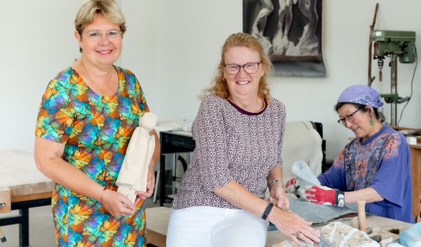 Hanna Tjerks (l) en Marion Bakker van Atelier 6. Op de achtergrond is een kunstenares aan het werk.