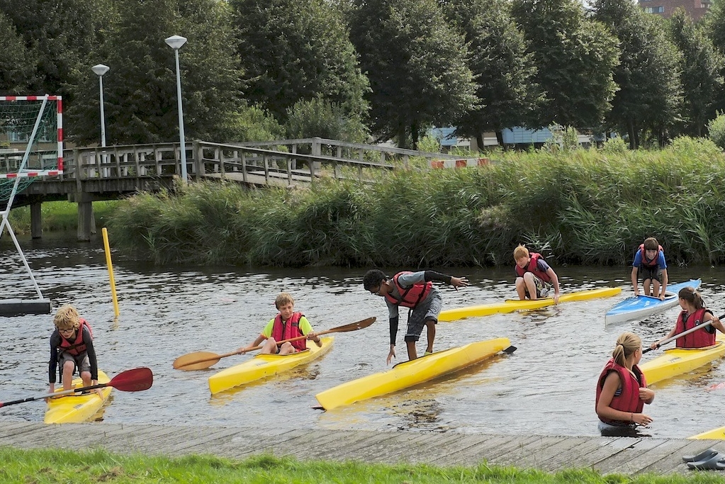 De deelnemers van de kanovakantieclub proberen in hun kano te staan. (Foto: Kanovereniging Viking)