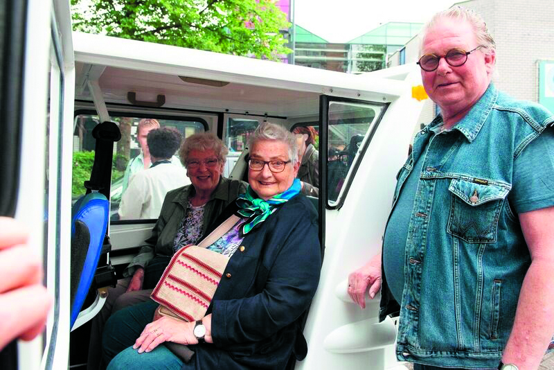 De vrijwillige chauffeur houdt de deur open, de eerste passagiers nemen plaats in de Zoefzoef. (foto aangeleverd)