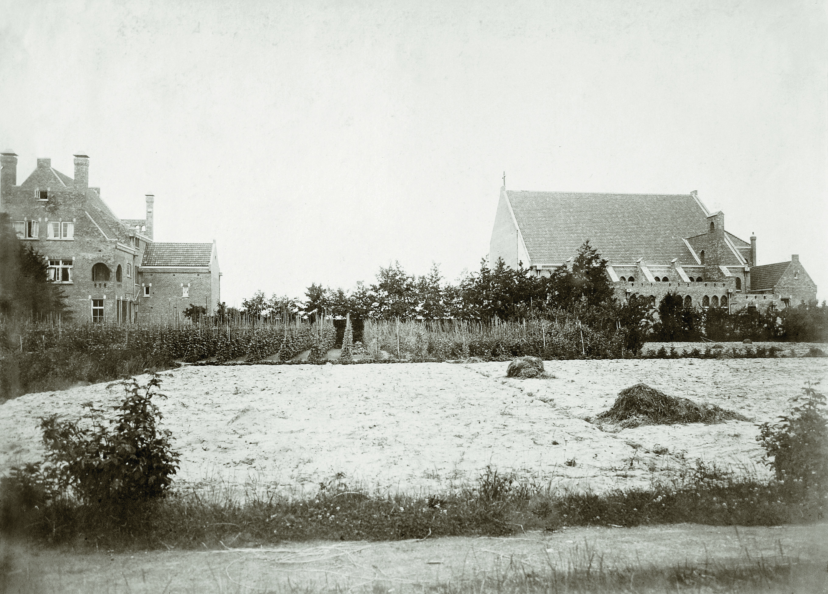 Tussen de kerk (rechts) en de pastorie (links) gaapte in 1915 een flink gat, dat pas later werd opgevuld met een patronaatszaal en de entreepartij met toren (1927). (FOTO: AANGELEVERD)