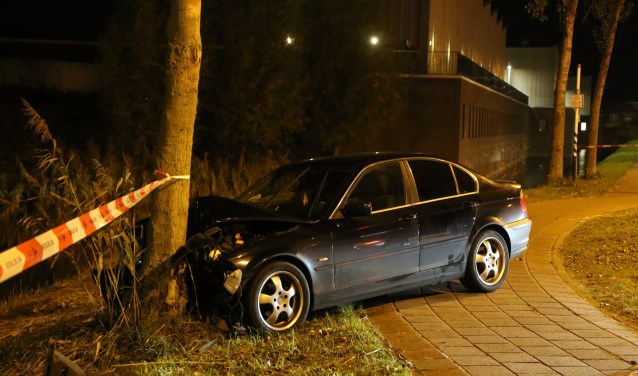 De auto is op de rotonde van de Grote Woerdlaan met de Bosweg tegen een boom gebotst en de vier verdachten zijn hierna te voet de wijk in gevlucht. (Foto: Daan van den Ende/Regio15)