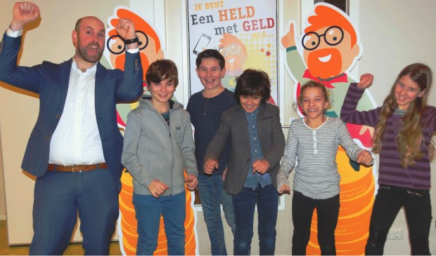 Leerlingen van Basisschool de Spoorzoeker bij de start van de wedstrijd ‘Je bent een held met je geld als…’ samen met Boaz Adank, wethouder.