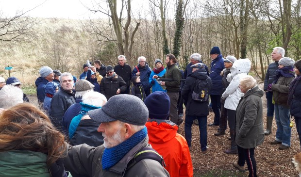 Landschapsarchitect Jan van Minnebruggen (middenachter met baard) vertelt de wandelaars dat hij hier een betere verbinding tussen Nollebos en boulevard voor zich ziet.