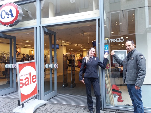 Chantal van Hoof (l) (beveiliger) en Sander van Breugel (r) (teamleider retail security) beiden van Trigion bij een winkel met de sticker van de Collectieve Winkelontzegging.