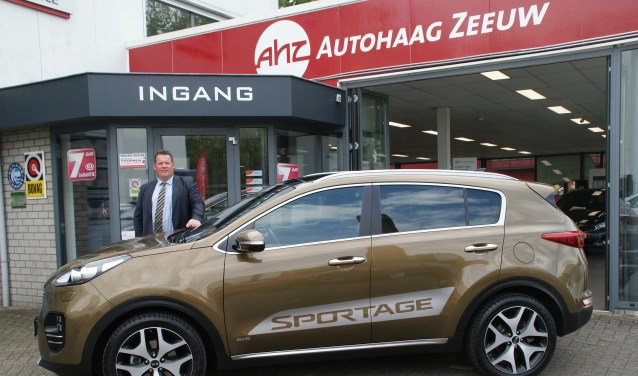 Verkoper Peter Eggermont bij de KIA Sportage, één van de topmodellen in de showroom van KIA Autohaag Zeeuw.