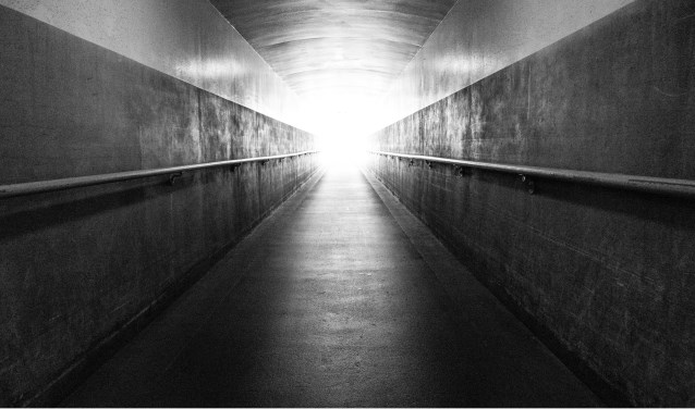 A long underground corridor leads up the the surface and the light at the end of the tunnel