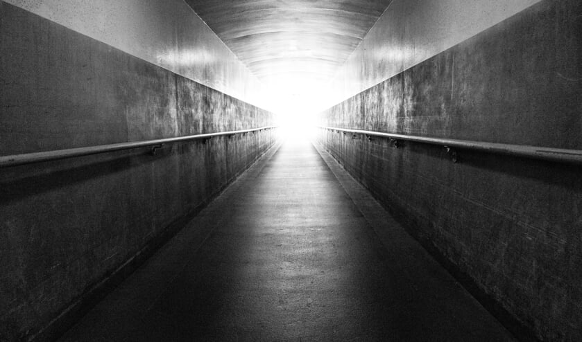 A long underground corridor leads up the the surface and the light at the end of the tunnel