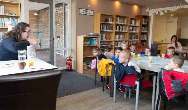 Laurianne Verhagen leest schoolkinderen voor in de bieb van 't Blickvelt.