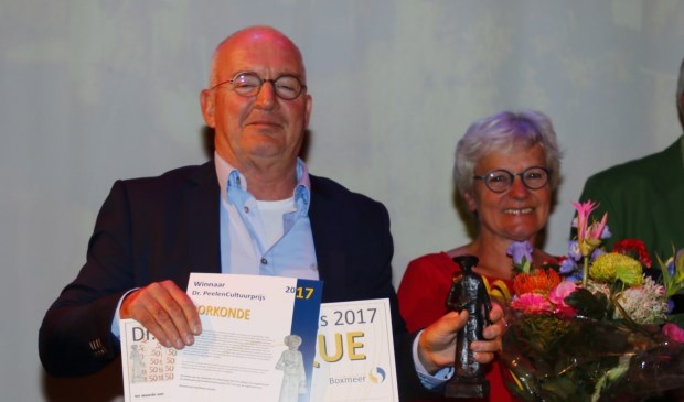 Cultuurprijswinnaar Henk van Os met de oorkonde en het Dr. Peelenbeeldje.