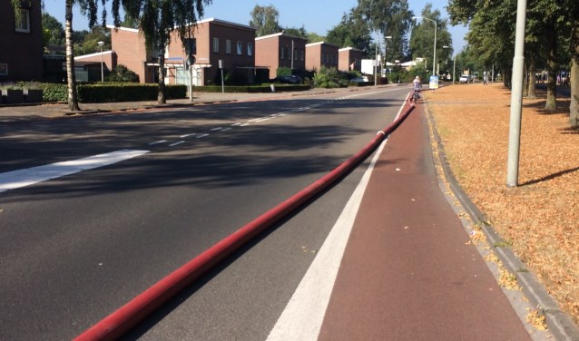 De brandslang die over de weg lag