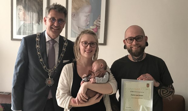 Charlie met haar trotse ouders en burgemeester Wim Hillenaar.