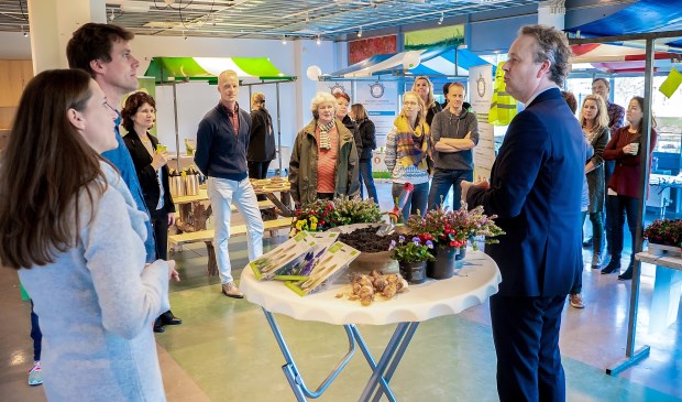Duurzaamheidswethouder Willem Joosten opende de bewonersmarkt. Geheel links staan Marieke van Leeuwen van het MEC en Sjoerd Luiten van het IVN.