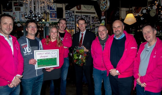 Het bestuur van de Vrienden van het Oude Dorp (in roze vesten) met tweede van rechts voorzitter Fried de Rave samen met Sven Vletter van het PC Hooftcollege (tweede van links) en Vriend van de Vrienden Kees van Haasteren (vierde van rechts).