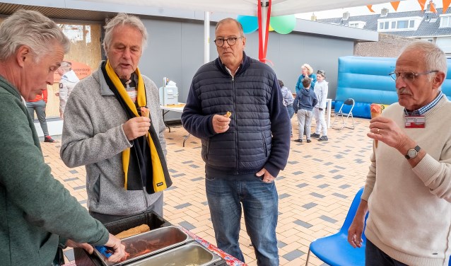 Bestuursleden Robert Laan (tweede van links) en Jaap Timmermans (geheel rechts) genieten van een ijsje op het verjaarsfeest van \t Buurthuis. | Foto: J.P. Kranenburg