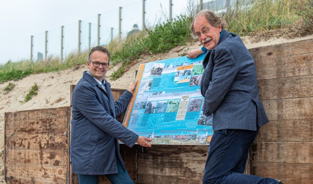 Wethouder Jacco Knape (links) en voorzitter Jack VlielandDUNAatelier plaatsen het informatiebord.