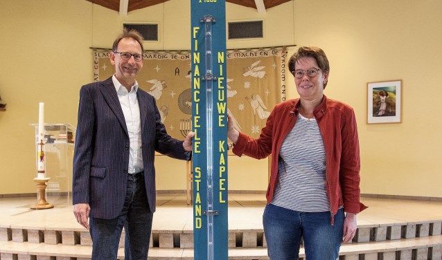 Gert Binnendijk en Astrid Buskermolen bij de thermometer, waarop de stand wordt bijgehouden. | Foto: Adrie van Duijvenvoorde
