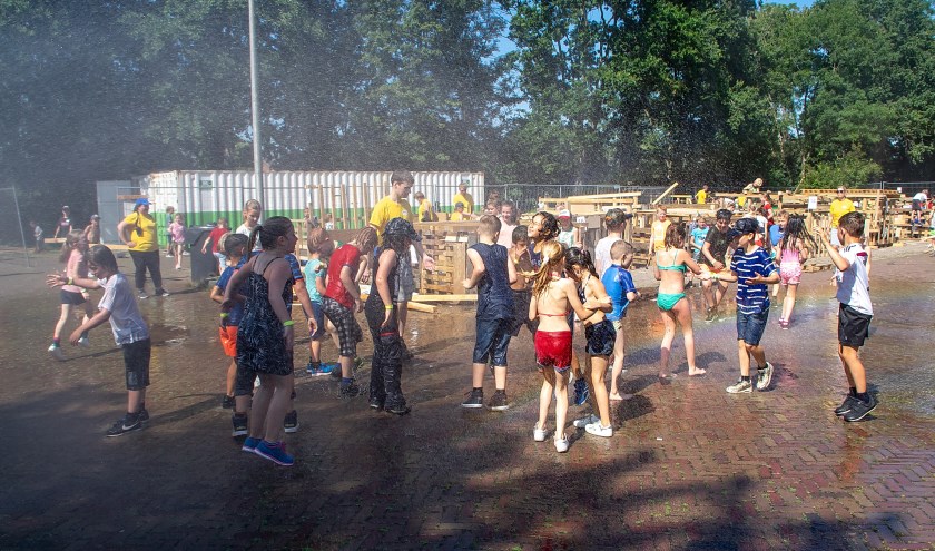 Tussen het huttenbouwen door genieten van een verkoelende artificiële regen.