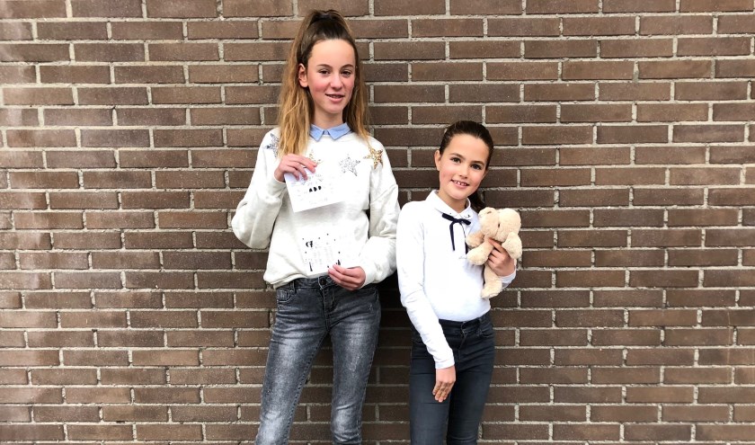 Maike Clement (12) en Indy Dautzenberg (11) nodigen iedereen uit om zaterdag 8 december met hen hun creativiteit in te zetten voor het goede doel