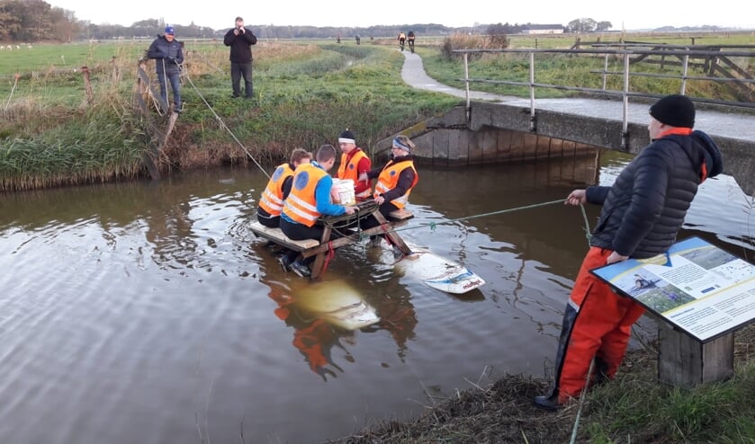 Emmers water vullen, zittend op een picknicktafel op het water.