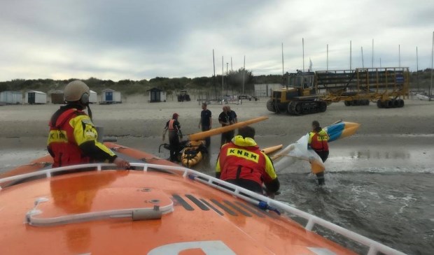 De catamaran wordt aan wal gebracht.