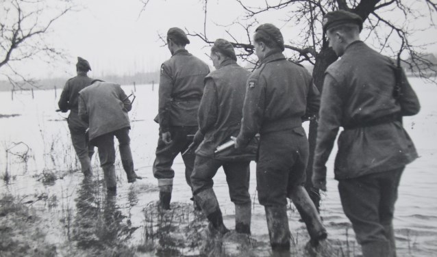 Britse soldaten waden door het overstroomde niemandsland. (foto: Ferdinand van Hemmen)